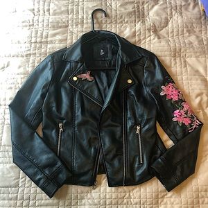 Black leather jacket with flower patch